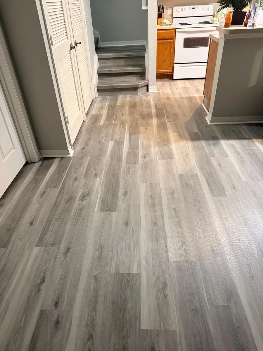 Wide-plank luxury vinyl flooring in a bright open living room