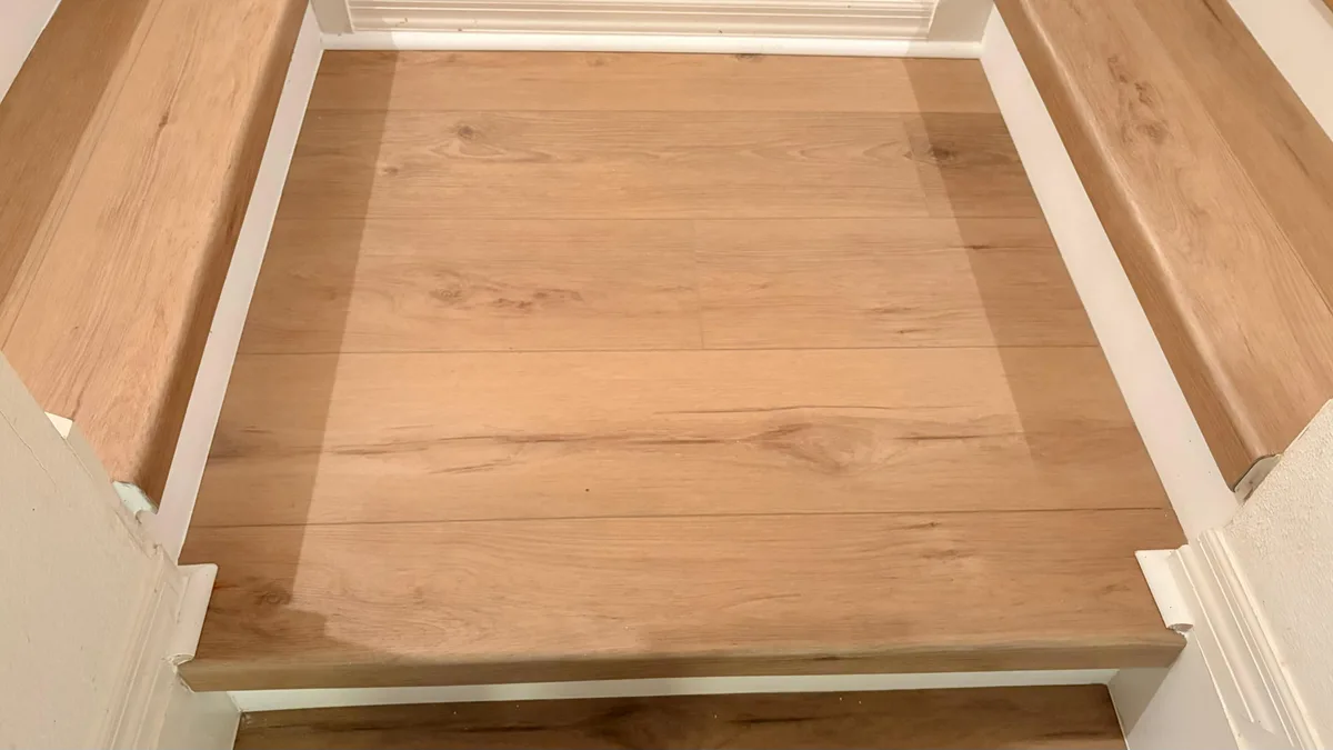 Luxury vinyl plank stair treads with matching landing floor
